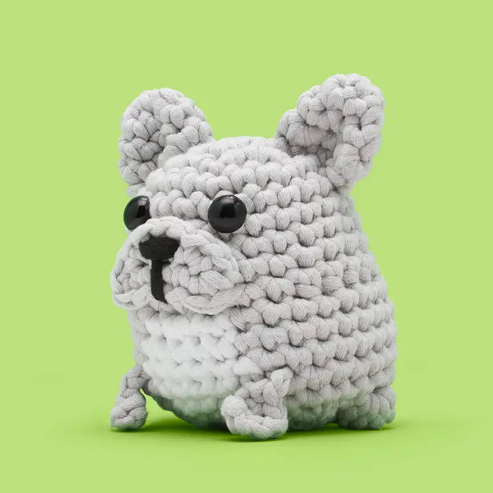 Diagonal view of a gray crocheted dog