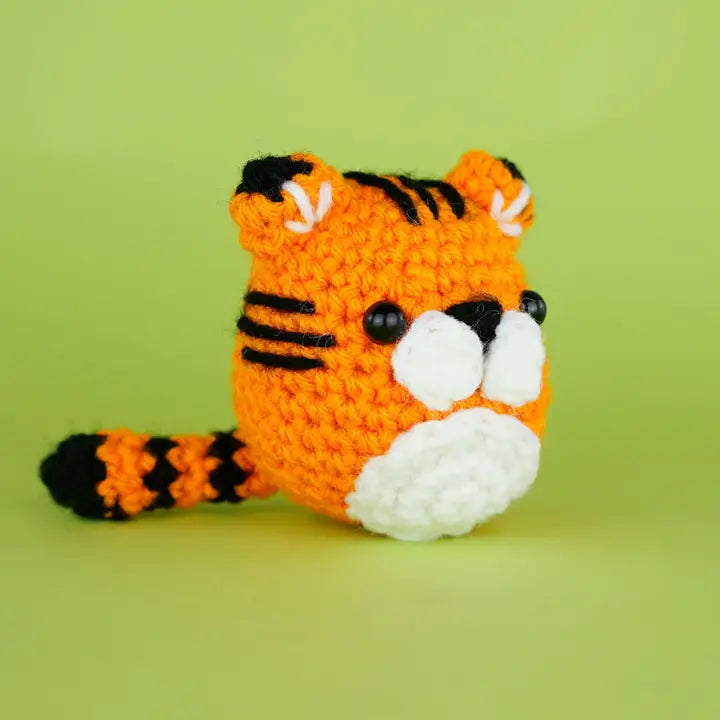 Side view of an orange crocheted tiger