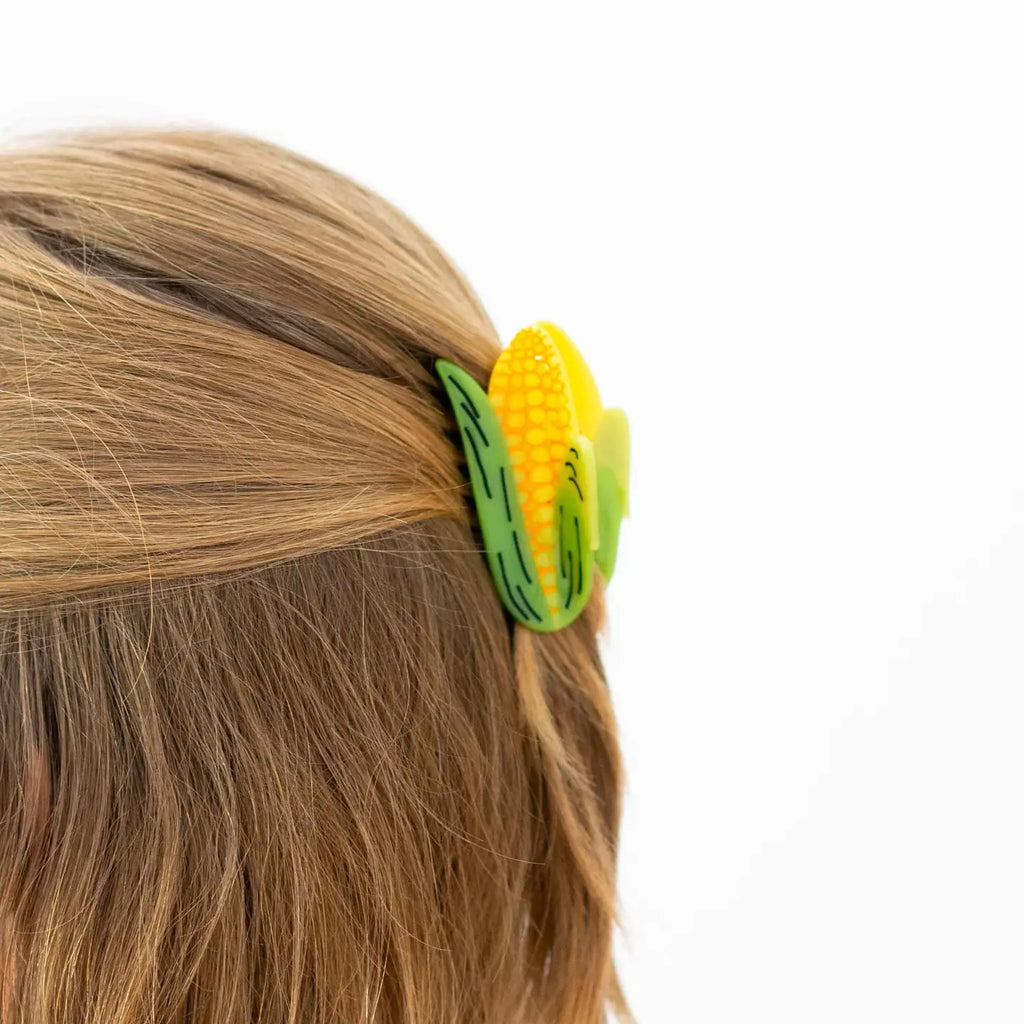 Image of corn hair clip in long dirty blonde hair worn half up half down 