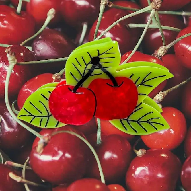 image of cherry hair claw sitting on a pile of real cherries 