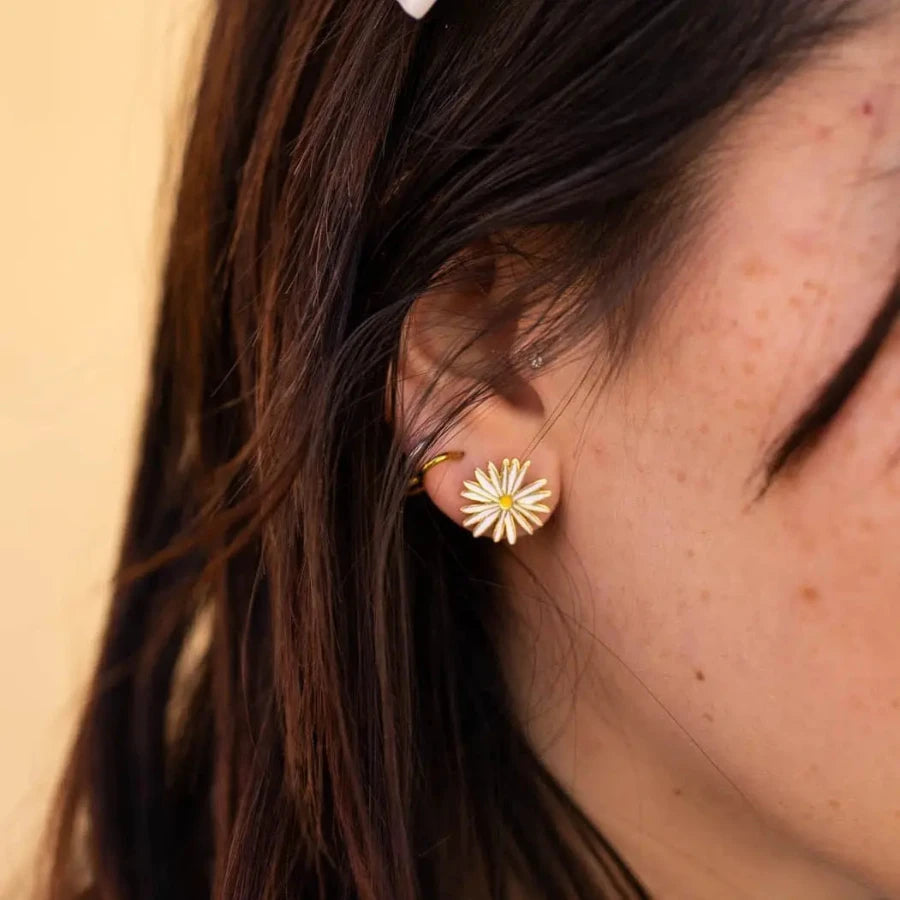 Photo of light skinned brown haired person modeling the stud earring 